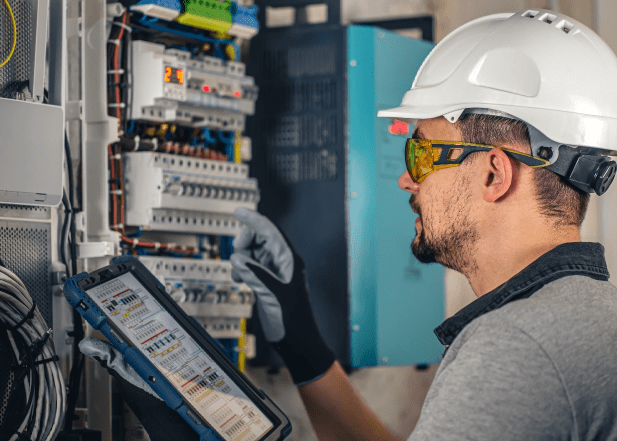 Man-Electrical-Technician-Working-Switchboard-With-Fuses@2X